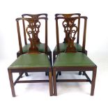 A set of four late 18th century mahogany and green faux leather dining chairs,