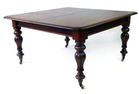 A Victorian mahogany telescopic extending dining table, with two fitted leaves,
