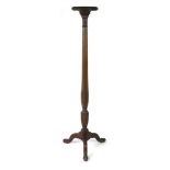 A George III-style mahogany torchere stand with stiff leaf carving and boxwood line inlay to the