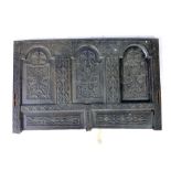 A 17th century-style carved oak panel, with foliate lunette carving,