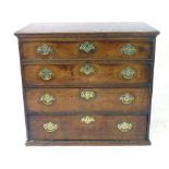 A George III oak chest of four graduated long drawers with cockbeading,