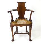 A reproduction George II style mahogany elbow chair,