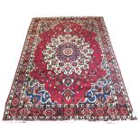 BAKHTIARI CARPET, 311cm x 205cm, sapphire and ivory rosette medallion on ruby field.