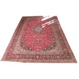 VERY FINE KASHAN CARPET, 423cm x 292cm, of sapphire and ivory medallion on ruby field with scrolling