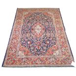 KASHAN RUG, 203cm x 134cm, of ivory and cerise medallion on sapphire field within corresponding