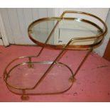 DRINKS TROLLEY, brass framed with two ro