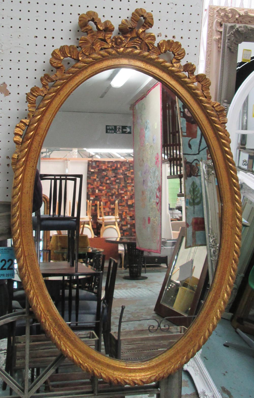 MIRROR, Louis XV style, oval in an ornate gilded frame, 86cm x 56cm.