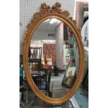 MIRROR, Louis XV style, oval in an ornate gilded frame, 86cm x 56cm.