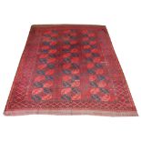 ANTIQUE AFGHAN CARPET, 290cm x 215cm, elephant feet guls on a ruby field.