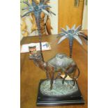 CANDLESTICK HOLDER, in the form of a camel and palm trees, 44cm H x 21cm W x 13cm D.