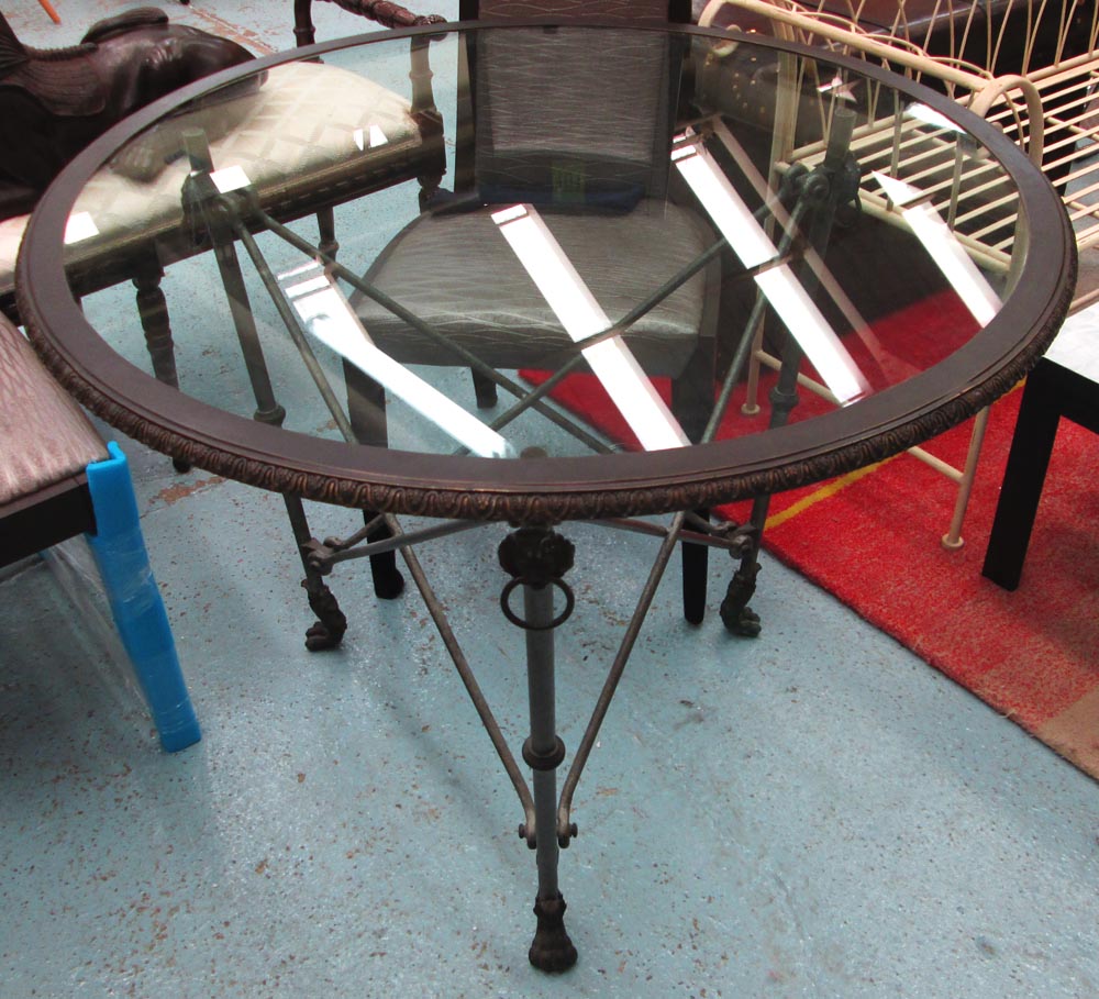 RALPH LAUREN CENTRE TABLE, circular, with glass top on a bronze effect metal base on claw supports,