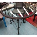 RALPH LAUREN CENTRE TABLE, circular, with glass top on a bronze effect metal base on claw supports,