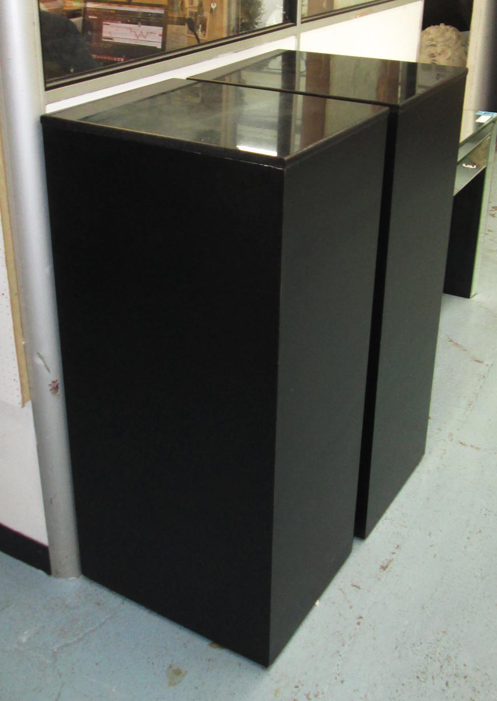 PEDESTALS, a pair, black finish with black marble tops, 45cm x 55cm x 121cm H. (2)