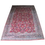 FINE TABRIZ CARPET, 328cm x 222cm, palmettes and vines on a claret field within corresponding bands