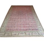ANTIQUE ANATOLIAN CARPET, 400cm x 273cm, all over design of scrolling vines and palmettes on cerise