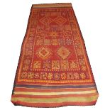 MID CENTURY BERBER RUG, 395cm x 149cm, various motifs on a terracotta field within bands and a