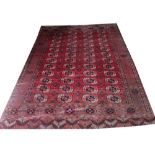 ANTIQUE TEKKE BOKHARA CARPET, 334cm x 254cm, rows of tekke guls on a rouge field within