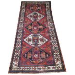 ANTIQUE KAZAK KILIM RUNNER, 301cm x 127cm, a row of medallions on a red field within bands and