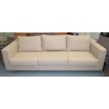 JACINTO USAN SOFA, three seater, in neutral fabric on metal tubular supports, 241cm L.