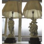 PARIAN TABLE LAMPS, a pair, modelled as a man and a woman, with pleated cream shades and on open