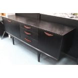 1960's SIDEBOARD, ebonised, with four drawers and cupboards below, on rounded supports, by