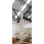 CHANDELIER, eight branches, of large proportions in a brass effect frame with glass drops, 271cm H,