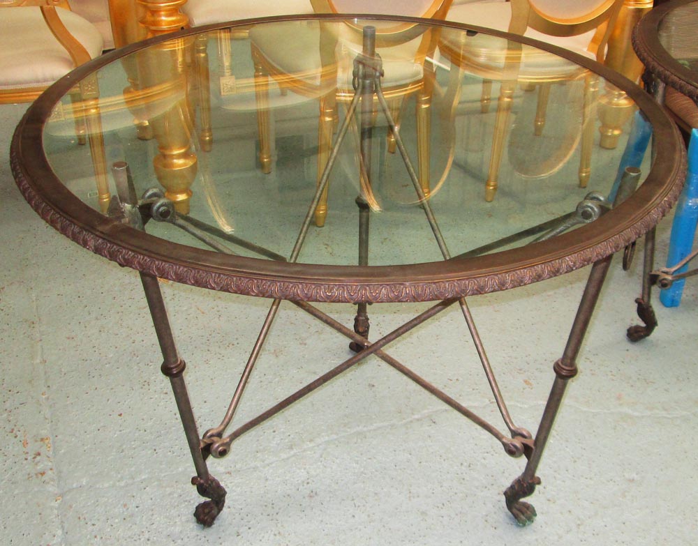 RALPH LAUREN CENTRE TABLE, circular, with glass top on a bronze effect metal base on claw supports,