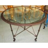 RALPH LAUREN CENTRE TABLE, circular, with glass top on a bronze effect metal base on claw supports,