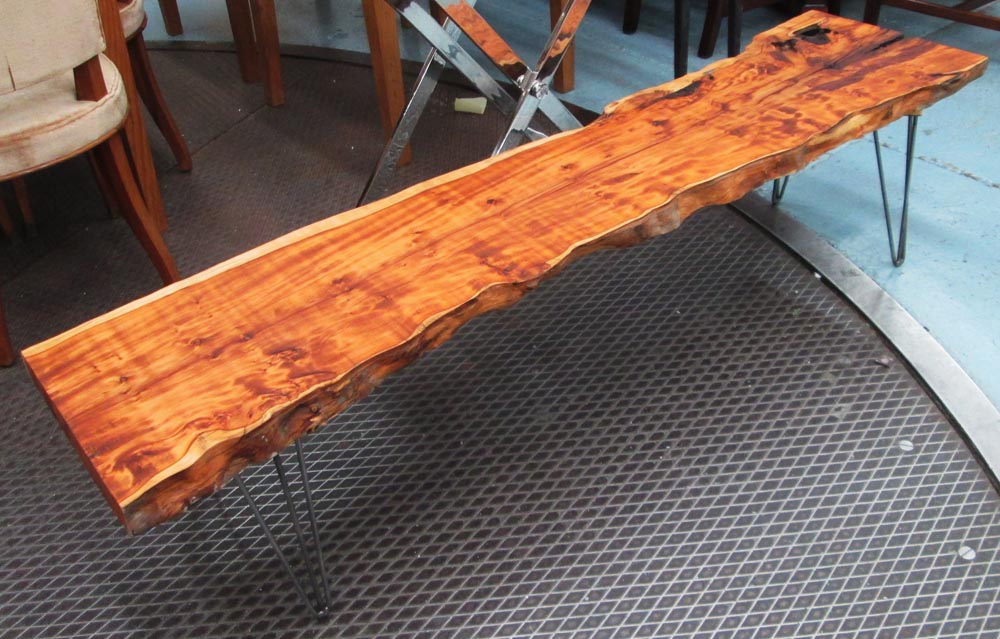 LOW BENCH/OCCASIONAL TABLE, cut from a tree trunk on metal supports, 170cm L.