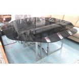 DINING TABLE, by Donghia/Rubelli, the rounded black glass octagonal top on a polished metal base,