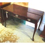 WRITING TABLE, mahogany with a rectangular top and three frieze drawers on cabriole supports,