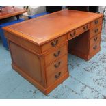 PEDESTAL DESK, with a rectangular tan leather tooled top and seven drawers below,