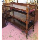 BUFFET, Victorian mahogany of three tiers on turned columns with large brass castors,