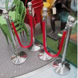 STANCHIONS, with two red velvetene ropes, 103cm H.