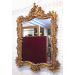 WALL MIRROR, Louis XV style, the gilt frame with floral and foliate detail, 66cm x 95cm H.