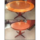 DINING TABLE, 1960's, Danish rosewood, circular with extending concentric segmented fold out leaves,