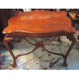 CENTRE TABLE, early 20th century mahogany with serpentine shaped top on claw and ball feet,