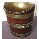 BUCKET, George III mahogany and brass bound of oval form with shallow liner, 26cm x 31cm.