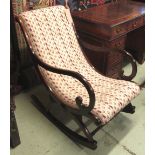 ROCKING CHAIR, Victorian style mahogany showframe with open scrolled arms and patterned upholstery,