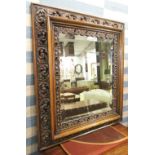 WALL MIRROR, late 20th century ash with pierced and carved frame with a bevelled plate,