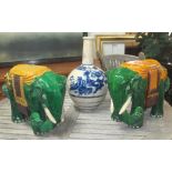 JARDINIERE STANDS, two similar, in the form of elephants in green glazed ceramic,