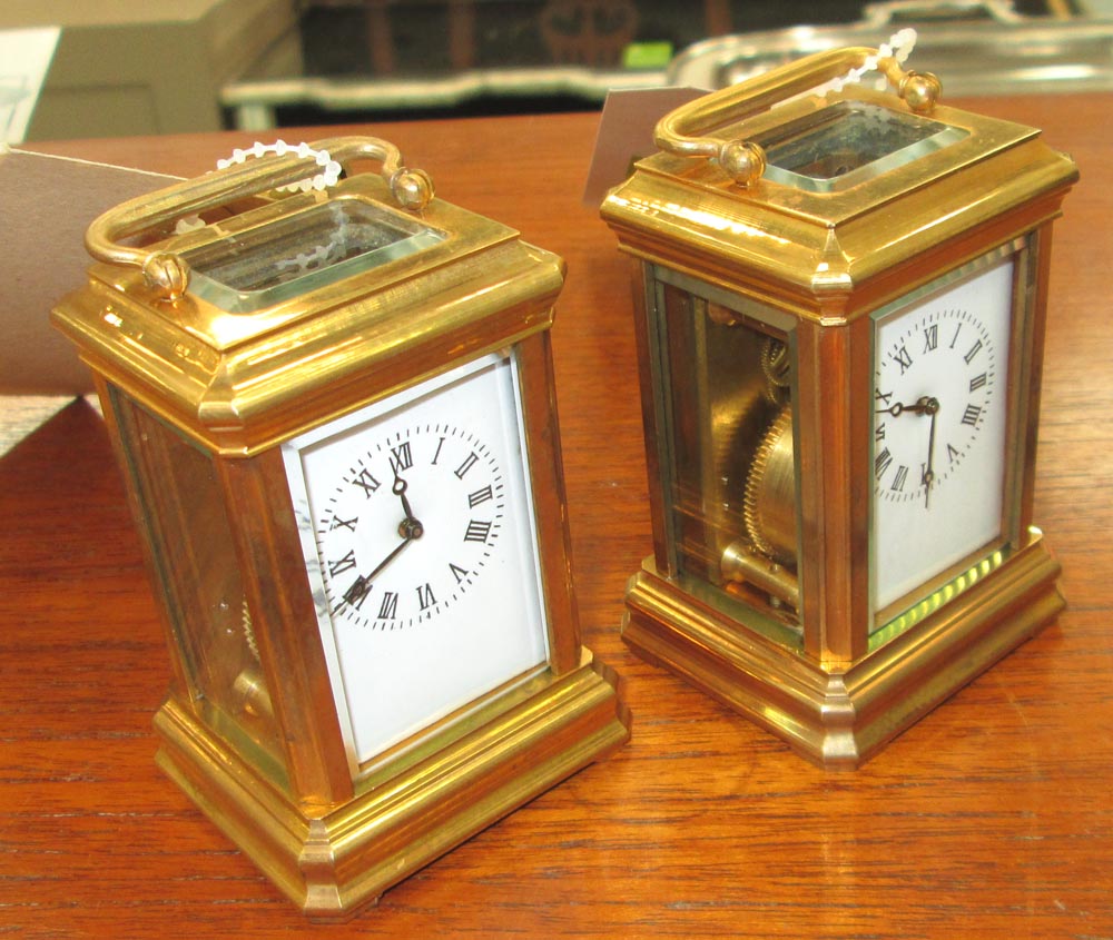 MINIATURE CARRIAGE CLOCKS, two, Swiss style, gold plated, white enamel face with Roman numerals,