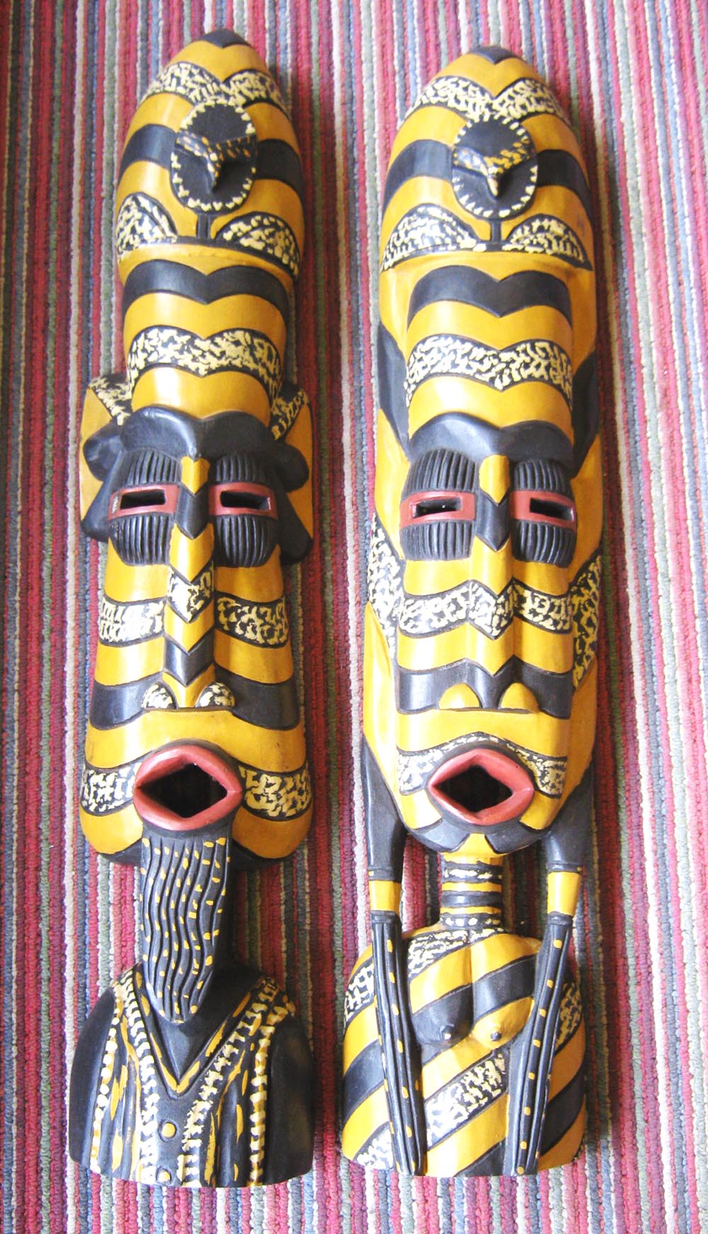 WEST AFRICAN MASKS, a pair, late 20th century, male and female, painted carved wood,