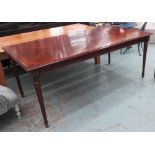 DINING TABLE, French style in mahogany finish with satinwood inlay on turned fluted supports,