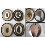 SILHOUETTE PENDANTS, a companion pair, signed Miers, framed oval with gold surrounds, 6cm H,