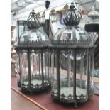 STORM CANDLE LANTERNS, a pair, 19th century style glass lined in metal frames with crown tops,