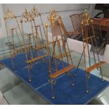 MINIATURE EASELS, a set of six, in gilded metal, 57cm H.