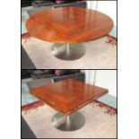 DINING TABLE, walnut veneer top, extending, circular with four fold down flaps on a stainless base,