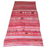 HIGH ATLAS KILIM, 350cm x 166cm, parallel bands in shades of red with various motifs.