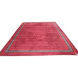 CARPET, 341cm x 485cm, burgundy with a red, black and grey border.